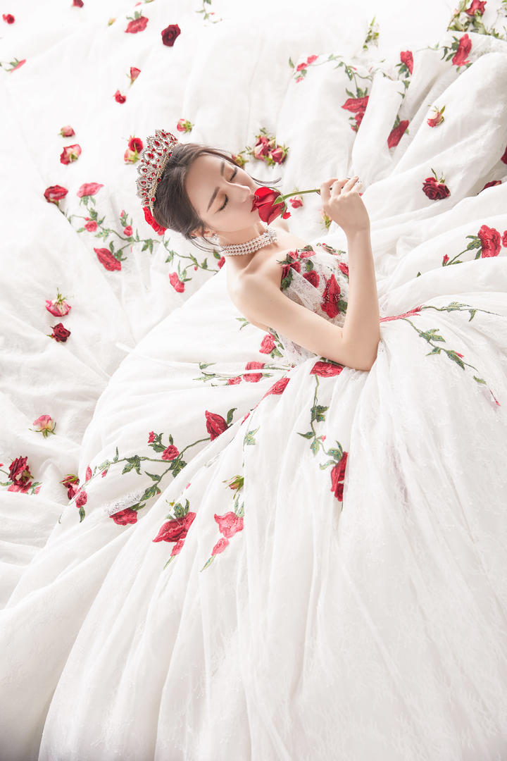 亲吻玫瑰花的内地女明星迪丽热巴婚纱照图片欣赏